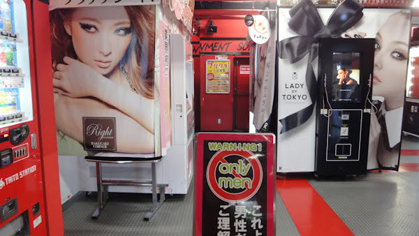 a floor with machines with women on them and a sign that says warning only men